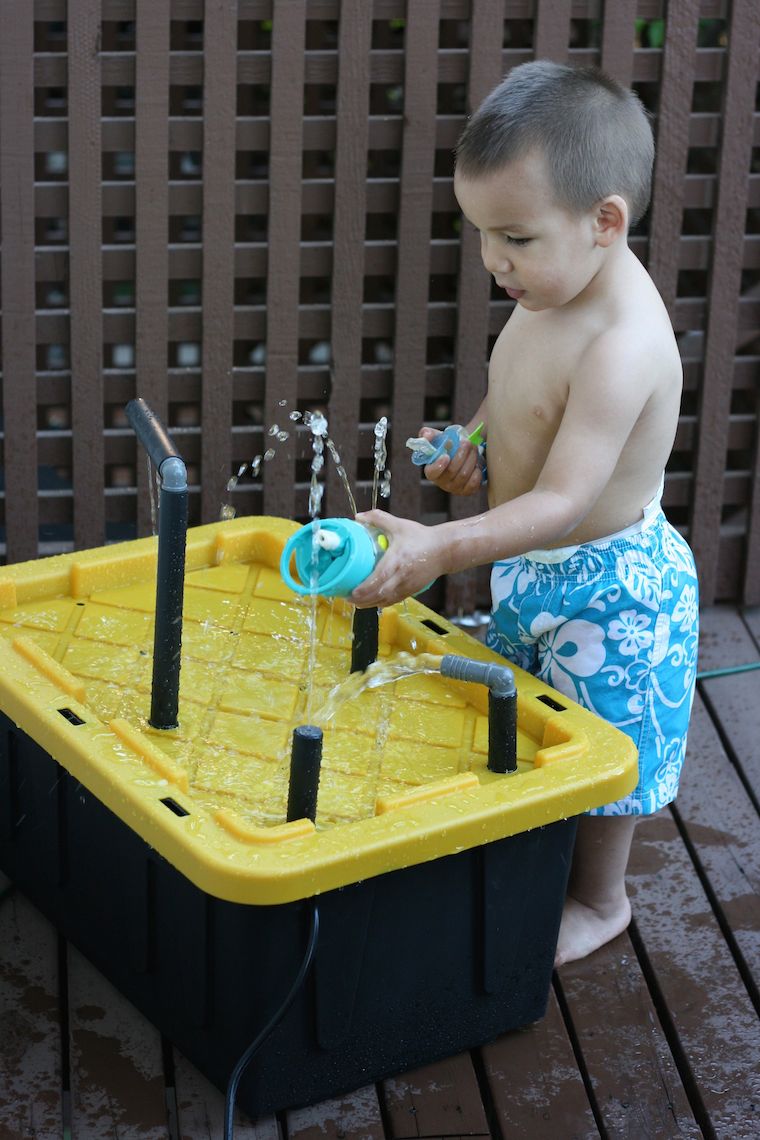 Upcycle a plastic storage container into an amazing DIY water spray table for kids with this fun weekend project! This would make a great birthday gift idea for a child and makes for hours of outdoor play!