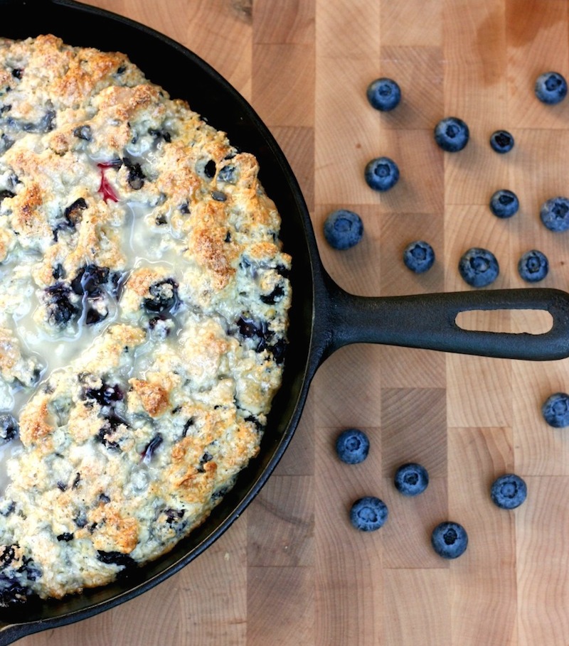 This Cast Iron Skillet Lemon Blueberry Scone Recipe is perfect for a no fuss weekend brunch or tea time. Sweet and tart, this recipe is easy to put together, looks pretty in the cast iron frying pan and is perfect for summertime entertaining.