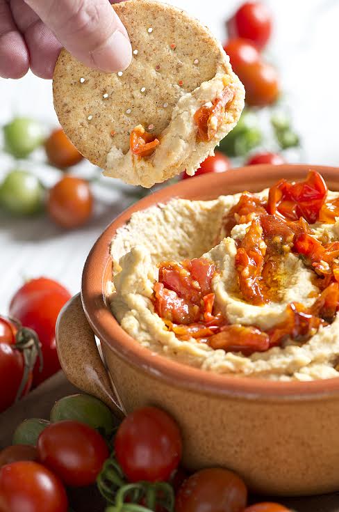 Learn how to roast cherry tomatoes and then use them to make a delicious roasted cherry tomato hummus recipe in this Building On Basics post from Hello Creative Family.
