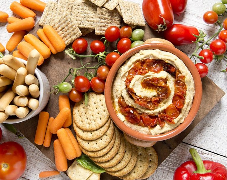 Learn how to roast cherry tomatoes and then use them to make a delicious roasted cherry tomato hummus recipe in this Building On Basics post from Hello Creative Family.