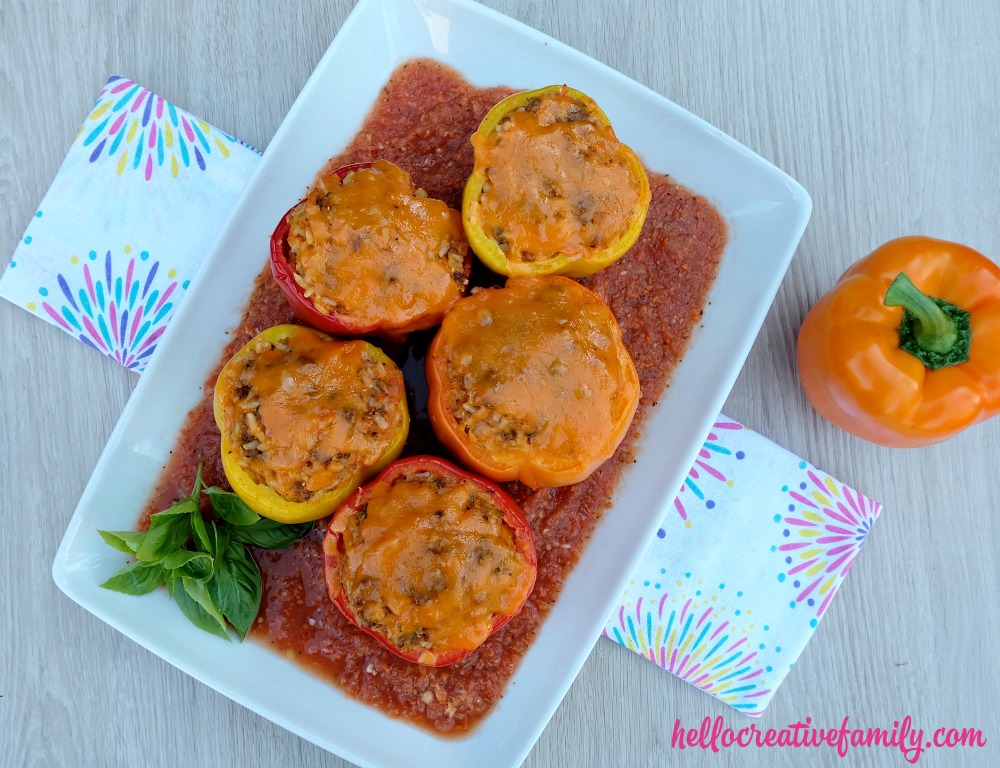 A quick and easy 30 minute weeknight meal idea! Italian Stuffed Bell Peppers Recipe with Rice, Ground Beef and Veggies! Parents will love it's packed full of hidden vegetables and kids will love the taste!