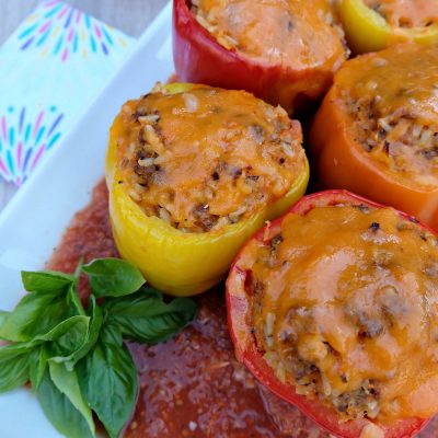 A quick and easy 30 minute weeknight meal idea! Italian Stuffed Bell Peppers Recipe with Rice, Ground Beef and Veggies! Parents will love it's packed full of hidden vegetables and kids will love the taste!