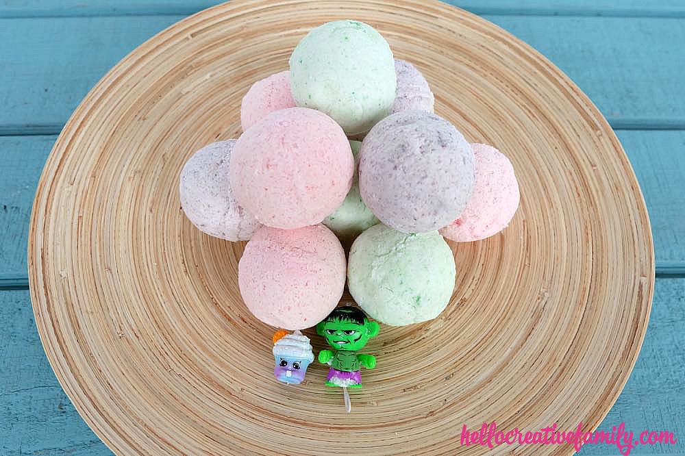 DIY your own handmade bath bombs, with this simple and easy tutorial which includes a video that walks you through step by step. This is a fun craft project for kids and makes bath time fun when kids discover the Shopkins or toy superhero hidden inside! Also makes a wonderful handmade gift for Christmas, Mother's Day, birthdays and other occasions. 