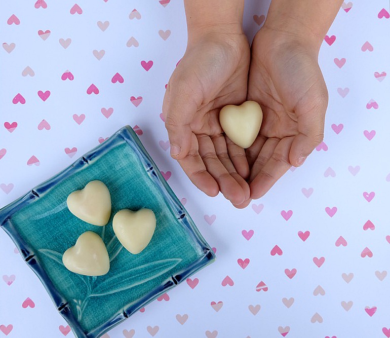 The perfect all natural solution for dry skin and cracked hands! These Easy DIY Lotion Bars Recipe are simple to make and would make a wonderful handmade gift idea! Perfect for teacher gifts, candy free Easter Egg stuffers, stocking stuffers and Valentine's day gifts!