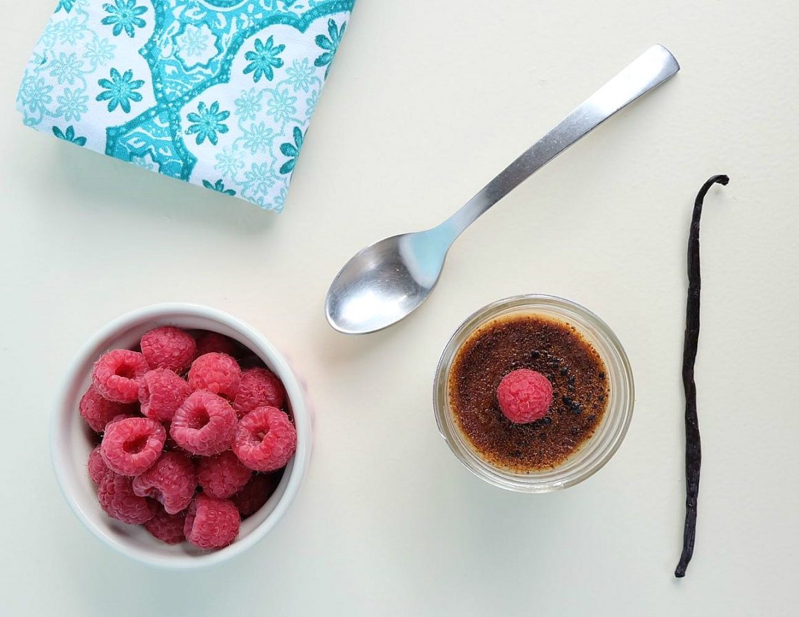 This Raspberry Crème Brûlée Recipe Made With Coconut Sugar is delicious and easy to make! The cream is infused with raspberries and vanilla beans. Topped with coconut sugar there are instructions on how to get the crunchy creme brulee top without using a kitchen torch! No special equipment required!