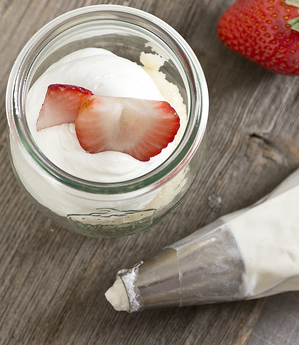 Mini desserts are incredibly easy & look gorgeous on any dessert table! This Mini Strawberry Shortcake Jars Recipe uses a doctored cake mix & fresh berries for an easy summertime dessert that's perfect for entertaining!