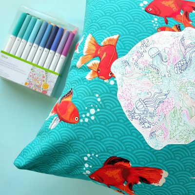 Create a gorgeous DIY Rainbow Under the Sea Pillow using your Cricut Explore to draw a coloring page design on printable heat transfer vinyl! This is an easy project that makes bright and colorful handmade gift idea. Includes instructions on how to sew an envelope style throw pillow cover.