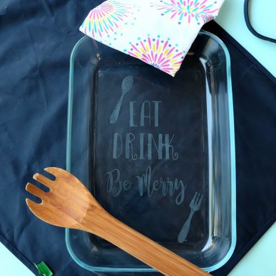 Making a gorgeous DIY Etched Glass Casserole Dish is so easy and makes a wonderful personalized handmade gift! Step by step photos are in this fun tutorial. A fun Cricut project that is perfect for wedding gifts, housewarming parties and entertaining guests! Includes a free cut file for the quote Eat, Drink, Be Merry!