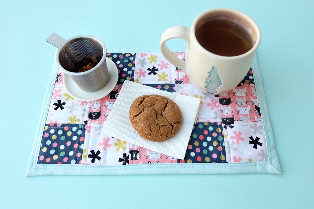 Bigger than a coaster and smaller than a placemat, a mug rug is a great handmade gift for coffee and tea drinkers! A great sewing project for beginners, this fabric scrap mug rug tutorial is easy and inexpensive to make! Cut the fabric with your Cricut Maker or by hand! #sewing #diy #craft #Cricutmaker