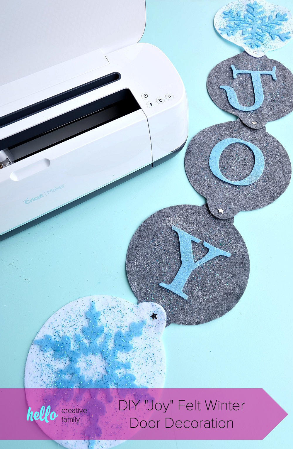 The new Cricut Maker cuts felt like butter! Learn how to make this DIY "Joy" Felt Winter Door Decoration in this no sew project that's perfect for a front door Christmas wreath substitute! How pretty are the sparkle snowflakes? #CricutMade #CricutHoliday #ChristmasCrafts #sponsored