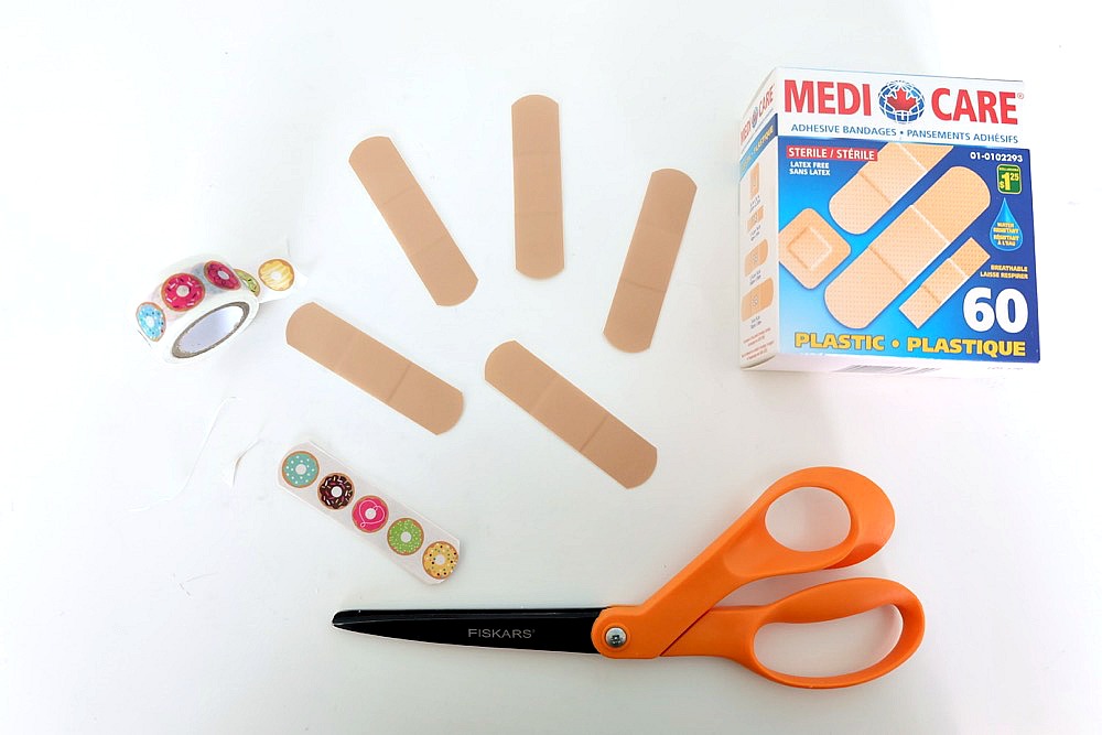 DIY Washi Tape Bandages are so easy to make! All you need is washi tape, scissors and a box of Bandaids! A fun, easy and inexpensive craft project that kids will love! A great activity for craft playdates, or birthday party activities!  Who knew a bandaid could be a cute fashion accessory? #washitape #crafts #diy