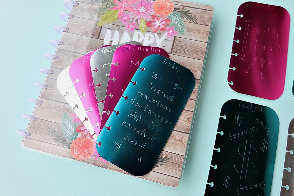 Making DIY Planner accessories is so much fun! Learn how to make foil embossed DIY planner dashboards using your Cricut Explore or Cricut Maker and a scoring stylus! This project includes 11 different options for your tabs. So easy to make. This project will kick your planner up a notch or two! #CricutMade #CricutHoliday #HappyPlanner #Planners #crafts #DIY