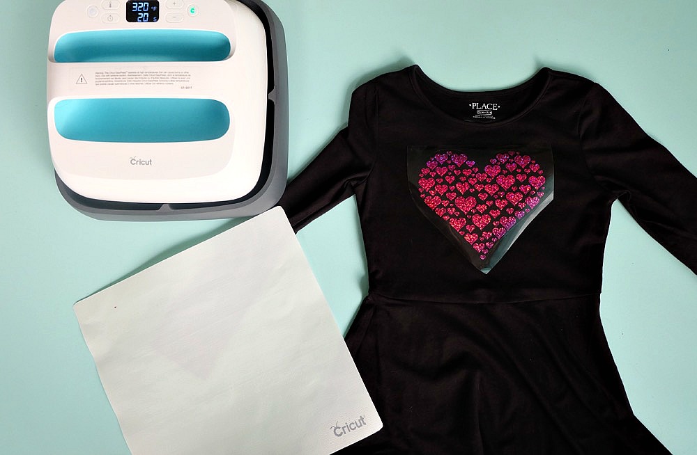 Celebrate Valentine's Day in style with this adorable DIY heart shirt! Make this project using your Cricut Maker or Cricut Explore. With this unique design one cut can make two shirts! Perfect for Valentine's Day parties or a handmade Valentine's Day or Galentine's Day gift. It would also make a fun BFF present! Includes free cut file! A fun shirt for kids or adults! #cricutmade #cricutmaker #cricutholiday