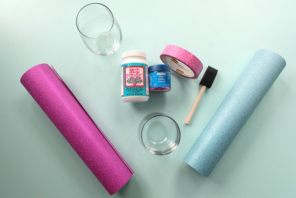 Celebrate Galentine's Day (aka Valentine's Day for with your BFF's) with these super cute DIY Glitter Dipped Wine Glasses. This post shares word art to make 6 different glasses along with an easy step by step tutorial with photos for how to make this project. This would be a great crafternoon project with friends! Use your Cricut to cut the word art. #CricutMade #Crafts #Galentine #DIY #Glitter #Valentine