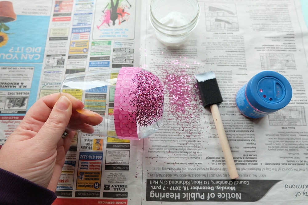 Celebrate Galentine's Day (aka Valentine's Day for with your BFF's) with these super cute DIY Glitter Dipped Wine Glasses. This post shares word art to make 6 different glasses along with an easy step by step tutorial with photos for how to make this project. This would be a great crafternoon project with friends! Use your Cricut to cut the word art. #CricutMade #Crafts #Galentine #DIY #Glitter #Valentine