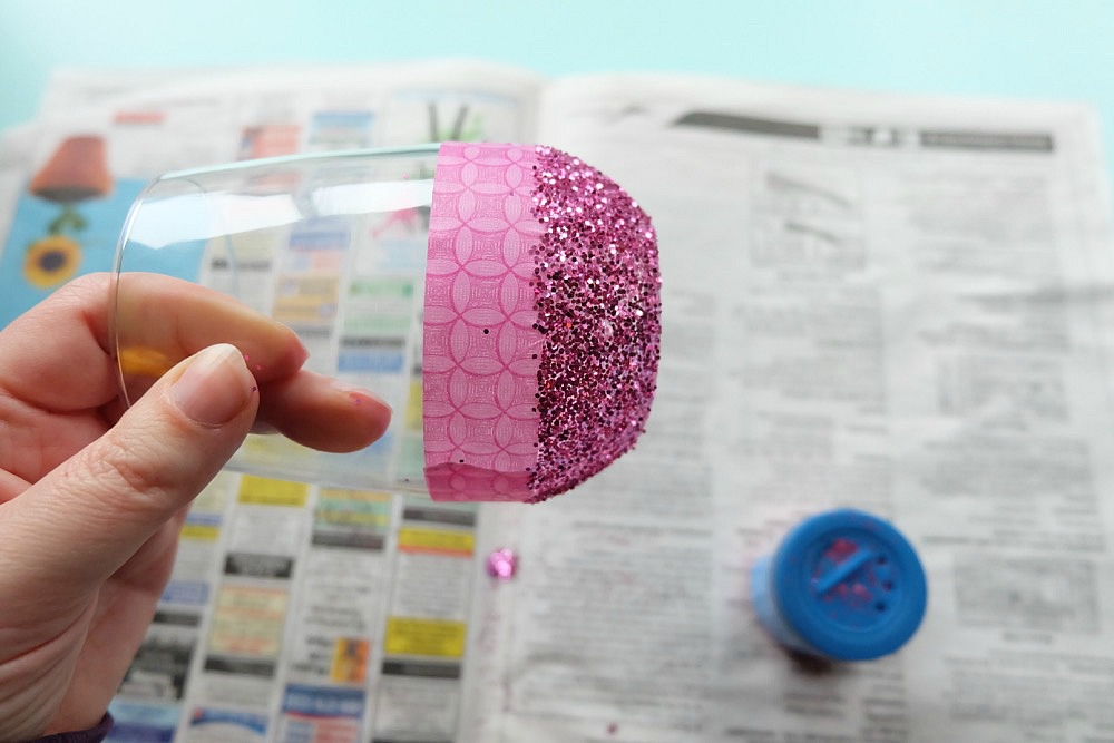 Celebrate Galentine's Day (aka Valentine's Day for with your BFF's) with these super cute DIY Glitter Dipped Wine Glasses. This post shares word art to make 6 different glasses along with an easy step by step tutorial with photos for how to make this project. This would be a great crafternoon project with friends! Use your Cricut to cut the word art. #CricutMade #Crafts #Galentine #DIY #Glitter #Valentine