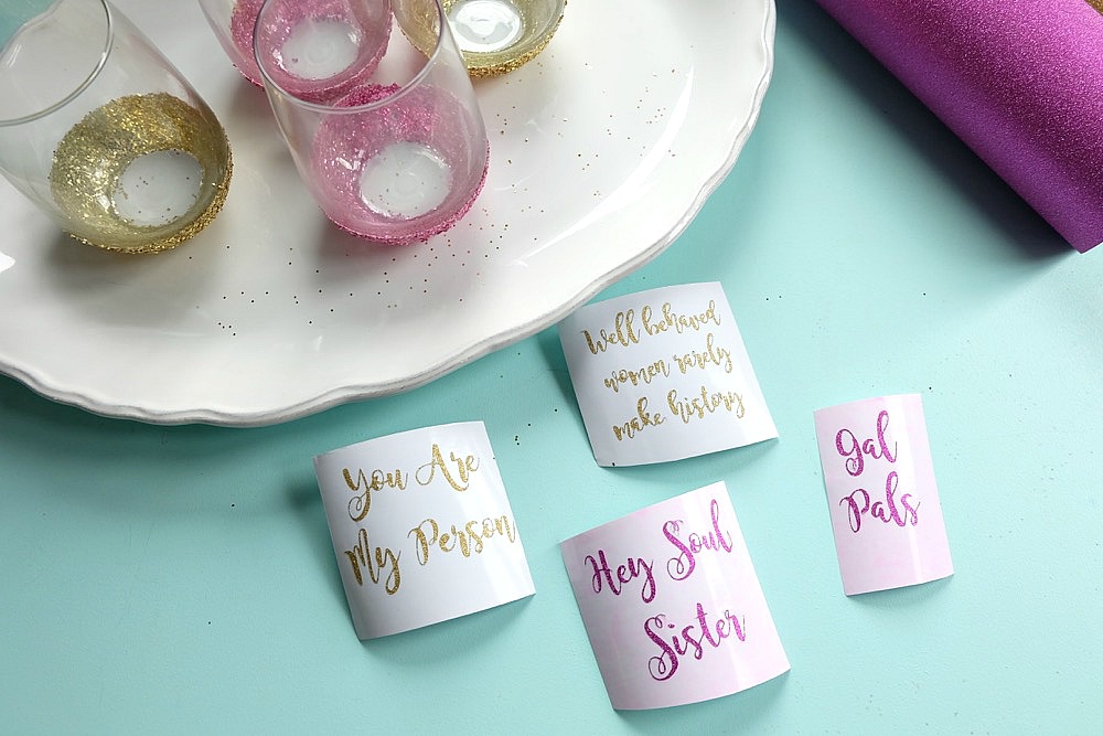 Celebrate Galentine's Day (aka Valentine's Day for with your BFF's) with these super cute DIY Glitter Dipped Wine Glasses. This post shares word art to make 6 different glasses along with an easy step by step tutorial with photos for how to make this project. This would be a great crafternoon project with friends! Use your Cricut to cut the word art. #CricutMade #Crafts #Galentine #DIY #Glitter #Valentine