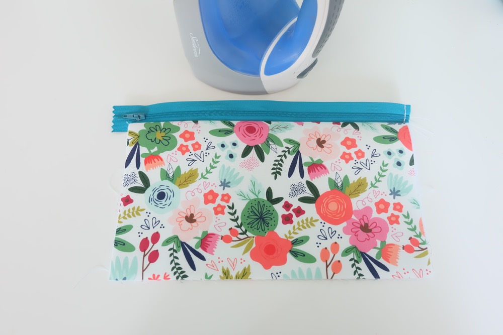 Every girl needs the perfect clutch, so why not make them! This easy sewing tutorial has step by step photos and instructions for making a DIY Wristlet Clutch Purse. Fit all of your essentials into this one little bag! Comes with a free cut file for making this craft project on the Cricut Maker. #Cricut #CricutMade #sewing #crafts