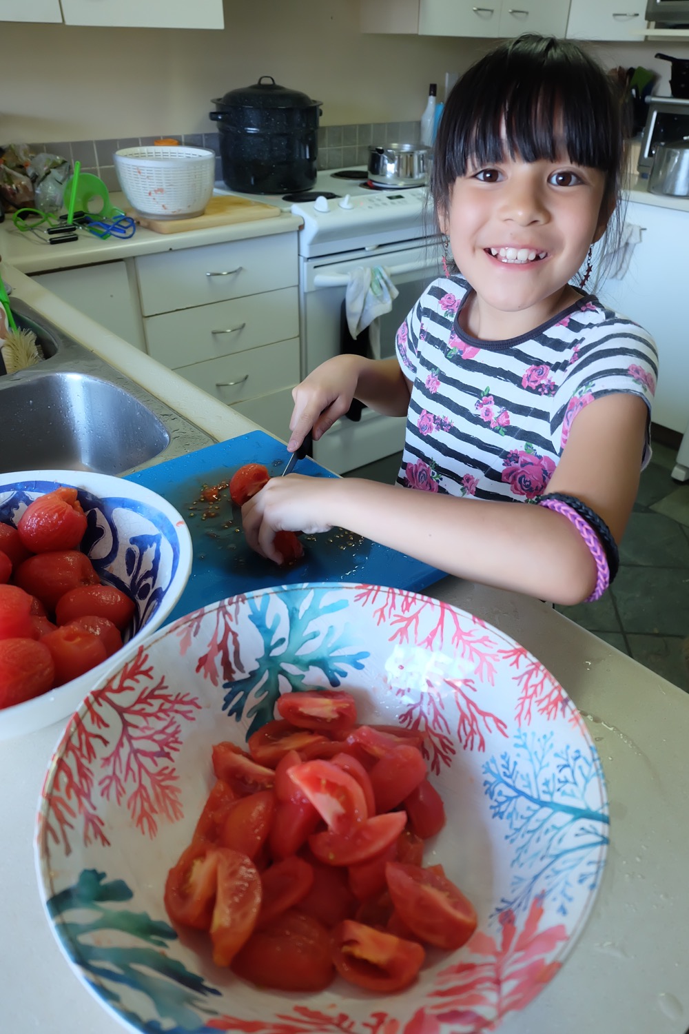 Get canning with your family this summer! We're sharing our top tips for canning with kids along with step by step photos and instructions for how to make our Easy Italian Herb Canned Tomatoes Recipe! We take all the intimidation out of canning so you can pass this handmade art along to your kids! #Canning #Recipe #Tomatoes #KidsCooking