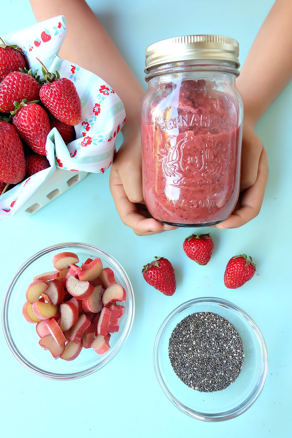 All the flavors of summer in one easy jam! This 15 minute strawberry rhubarb chia jam recipe takes two of my favorite flavors of summer and turns it into one healthy recipe! If you have never made jam before this is the recipe to start with. It uses chia seeds to thicken the jam instead of pectin. Family friendly, get the kids involved in the kitchen helping to make this delicious treat. Perfect for on bread, mixed with greek yogurt or as an ice cream topper! #Jam #chia #strawberry #rhubarb #recipe