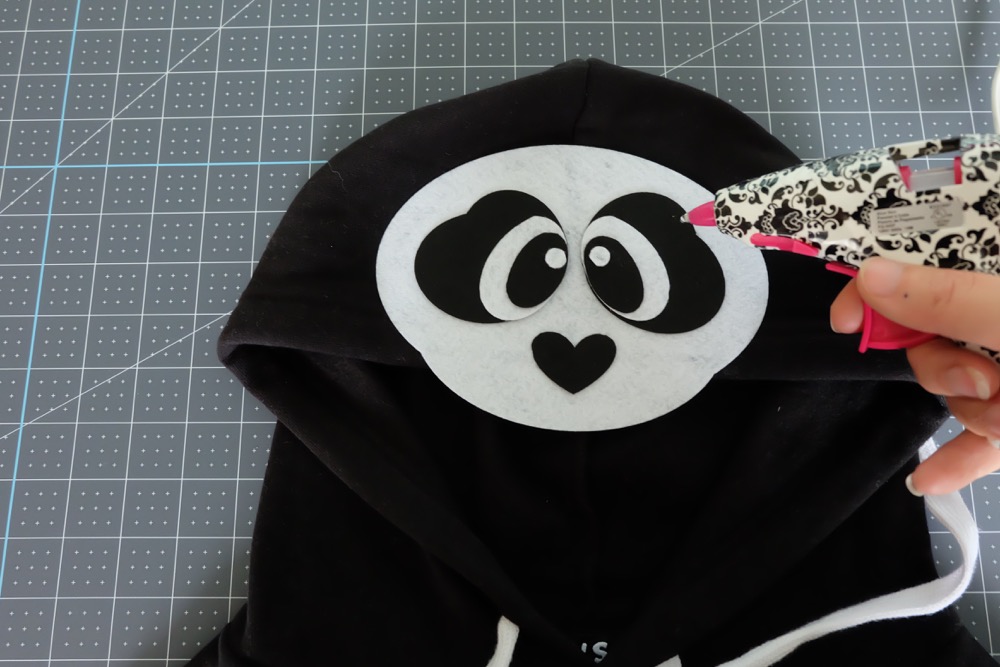 Looking for a fun idea for DIY No Sew Group Halloween Costumes? Look now further! We used HTV, felt a glue gun and our Cricut Maker to create these adorable zoo animal hoodies. We've got free cut files for a giraffe, parrot and panda! Make all three for a fun group halloween costume for kids or adults! #Halloween #DIY #GroupCostume #CricutMaker #Cricut #CricutMade #Sponsored
