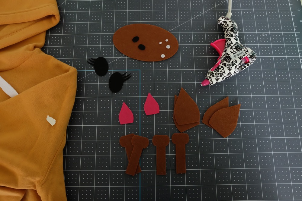 Looking for a fun idea for DIY No Sew Group Halloween Costumes? Look now further! We used HTV, felt a glue gun and our Cricut Maker to create these adorable zoo animal hoodies. We've got free cut files for a giraffe, parrot and panda! Make all three for a fun group halloween costume for kids or adults! A quick and easy Halloween Costume Idea that will take less than 30 minutes to make. #Halloween #DIY #GroupCostume #CricutMaker #Cricut #CricutMade #Sponsored