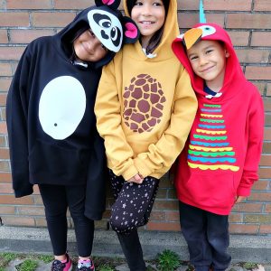 Looking for a fun idea for DIY No Sew Group Halloween Costumes? Look no further! We used HTV, felt a glue gun and our Cricut Maker to create these adorable zoo animal hoodies. We've got free cut files for a giraffe, parrot and panda! Make all three for a fun group halloween costume for kids or adults! A quick and easy Halloween Costume Idea that will take less than 30 minutes to make. #Halloween #DIY #GroupCostume #CricutMaker #Cricut #CricutMade #Sponsored