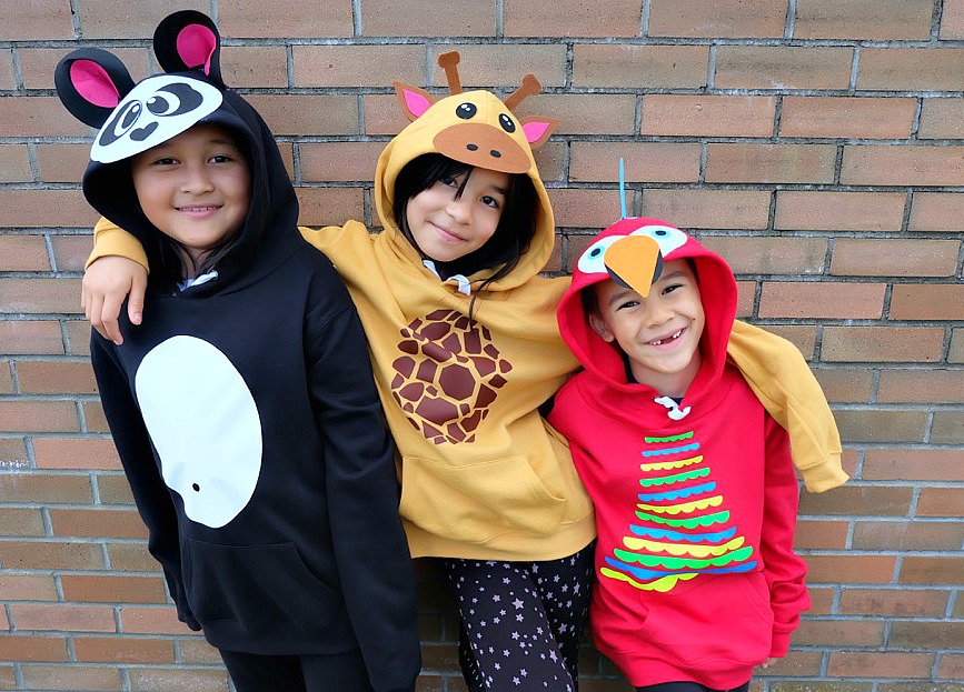Looking for a fun idea for DIY No Sew Group Halloween Costumes? Look now further! We used HTV, felt a glue gun and our Cricut Maker to create these adorable zoo animal hoodies. We've got free cut files for a giraffe, parrot and panda! Make all three for a fun group halloween costume for kids or adults! A quick and easy Halloween Costume Idea that will take less than 30 minutes to make. #Halloween #DIY #GroupCostume #CricutMaker #Cricut #CricutMade #Sponsored