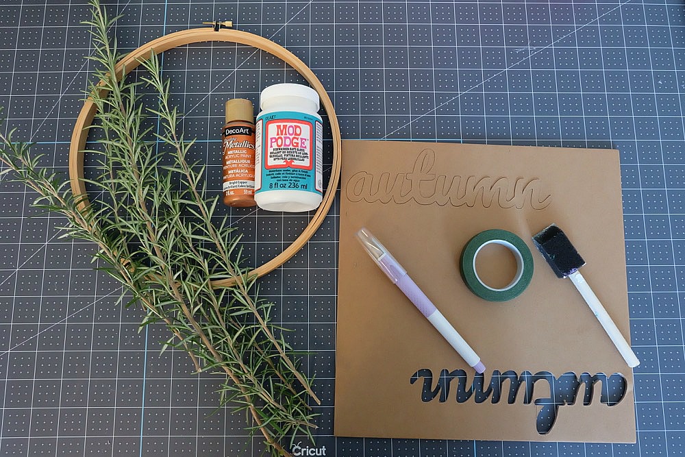 Create a simple DIY Rosemary Autumn Wreath to celebrate fall with our free Autumn SVG file and wreath tutorial. This project uses fresh rosemary from your garden, an embroidery hoop and a design cut from chipboard using your Cricut Maker. #Autumn #wreath #CricutMaker #Cricut