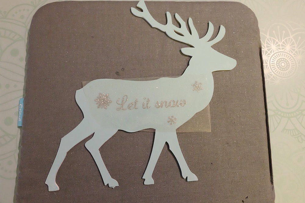 This beautiful DIY reindeer Christmas Ornament is cut using the Cricut Maker! Decorated with "Let It Snow" it makes a beautiful handmade gift idea! This step by step tutorial with photos teaches you how to cut chipboard using your Cricut Maker to make beautiful home decor items. Make handmade reindeer decorations as teacher gifts, gifts for mom, or gifts for a friend. #HandmadeGift #CricutMaker #Christmas #Reindeer
