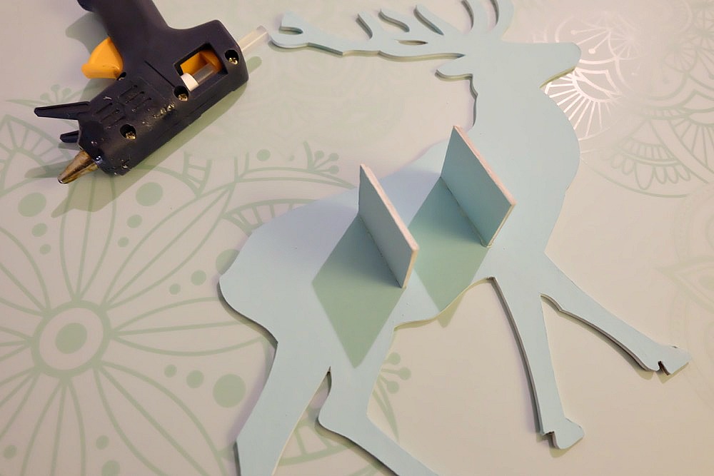 This beautiful DIY reindeer Christmas Ornament is cut using the Cricut Maker! Decorated with "Let It Snow" it makes a beautiful handmade gift idea! This step by step tutorial with photos teaches you how to cut chipboard using your Cricut Maker to make beautiful home decor items. Make handmade reindeer decorations as teacher gifts, gifts for mom, or gifts for a friend. #HandmadeGift #CricutMaker #Christmas #Reindeer