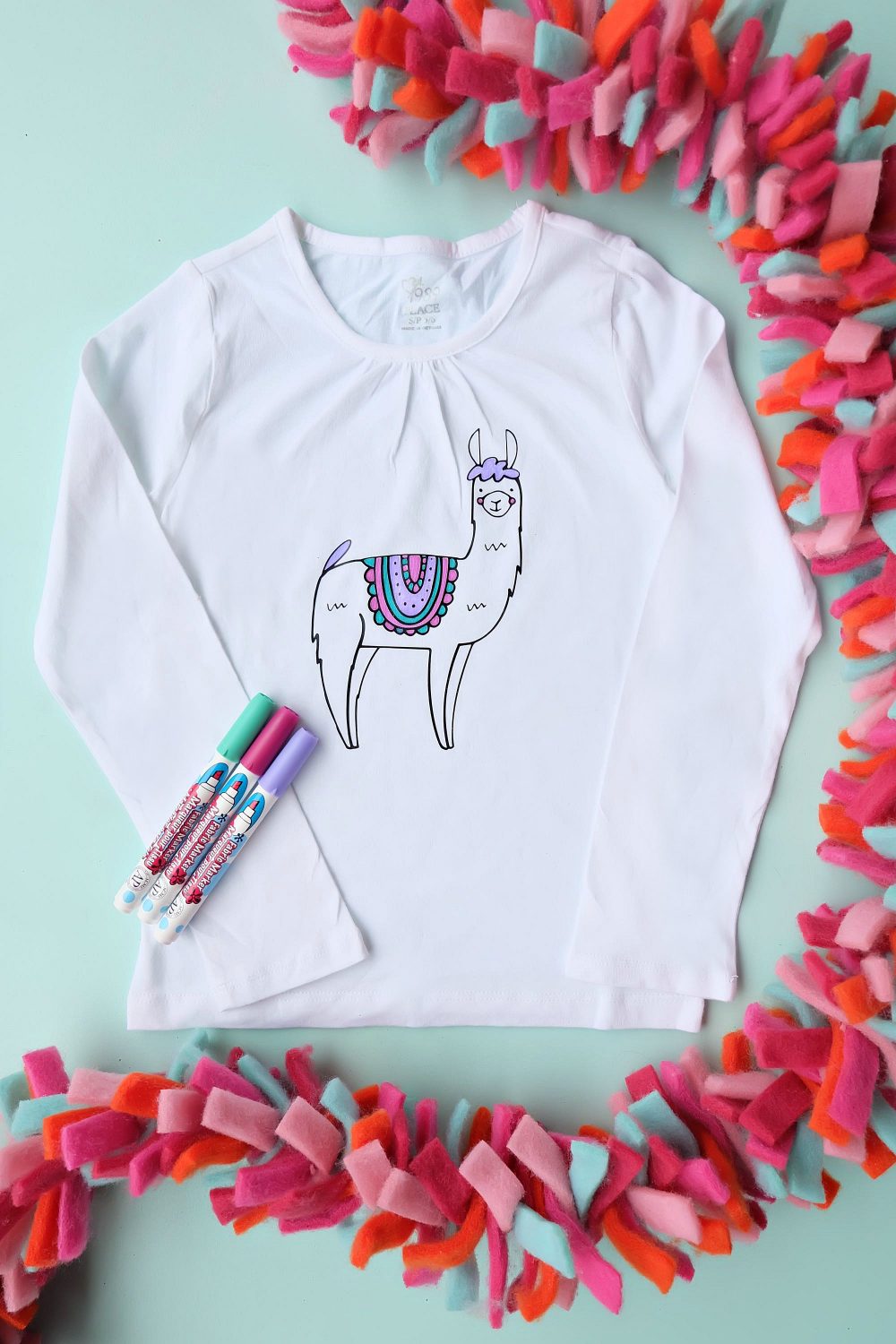 Are you in love with the llama crazy? We sure are! Make this Easy DIY Llama Coloring Shirt for a super fun handmade gift idea thats a kids craft and a piece of clothing in one! Cut using your Cricut Explore, Cricut Maker or Silhouette! #llamas #DIY #Cricut #Silhouette #Coloring