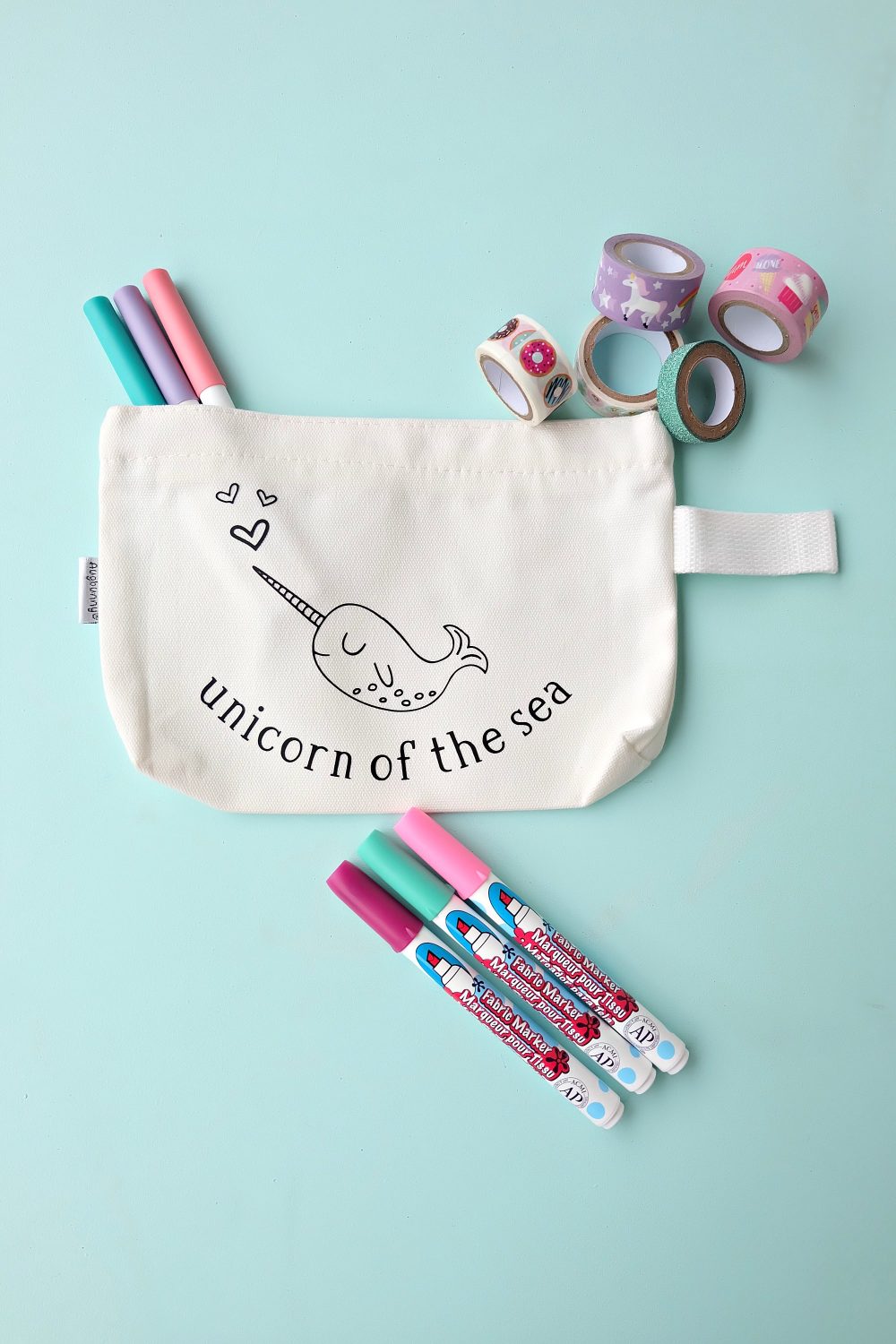 Create a sweet little DIY Narwhal Zippered Pouch that the recipient can color in! This thoughtful handmade gift takes only minutes to make and is a thoughtful handmade gift idea for kids (or adults!) It's a coloring sheet and a pencil pouch in one! #Cricut #Narwhal #DIY #Coloring