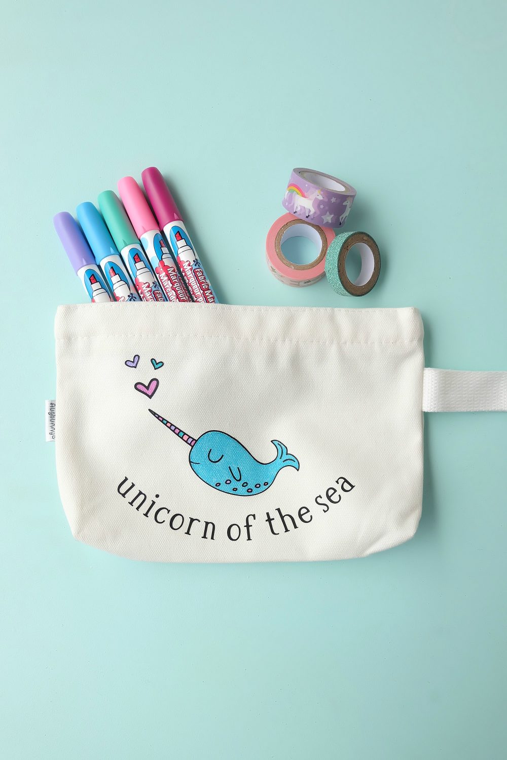 Create a sweet little DIY Narwhal Zippered Pouch that the recipient can color in! This thoughtful handmade gift takes only minutes to make and is a thoughtful handmade gift idea for kids (or adults!) It's a coloring sheet and a pencil pouch in one! #Cricut #Narwhal #DIY #Coloring