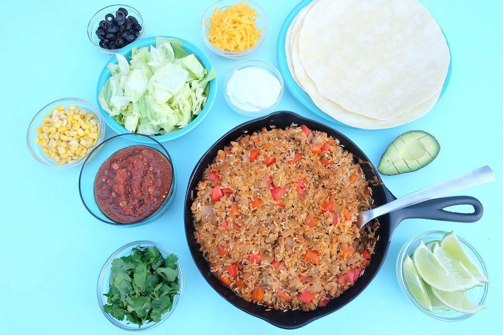 Looking for a quick and easy, one pan healthy dinner idea that will feed a crowd? This turkey and rice Mexican casserole recipe only takes 10 minutes to prep, then you pop it in the oven. Perfect for filling tacos, burritos or using as a topping for taco salad! A healthy, delicious and family friendly meal idea! #MakeItWithTurkey #Recipe #Mexican #Turkey #OnePan
