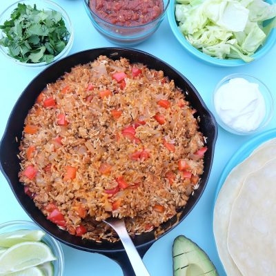 This quick and easy family friendly ground turkey and rice Mexican casserole recipe is a healthy one pan meal that takes 10 minutes to prep! Perfect for feeding a crowd or for multiple meals. Use it as a filling for tacos, burritos or as a topping for taco salad! #MakeItWithTurkey #Recipe #MexicanFood #Turkey #OnePan #sponsored