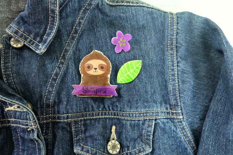 This fun craft will have you feeling nostalgic for the 80's! Learn how to make DIY Sloth Pins using Shrinky Dinks! Includes a free template for the sloth, flowers and leaves along with step by step photos and instructions! A super fun kids crafts that adults will enjoy too! Let's make flare pins! #Crafts #DIY #Sloths #shrinkydinks