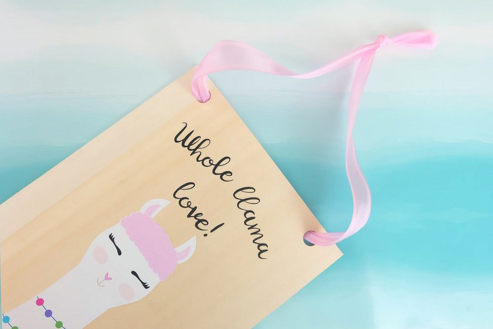 Learn how to cut basswood with your Cricut Maker and make this adorable DIY Llama Wood Wall Hanging featuring acute Print and Cut llama and the quote Whole Llama Love. This craft would make a sweet handmade gift and would be perfect for decorating a girl's bedroom or as a fun front door decoration. Another amazing Cricut Project from Hello Creative Family. #CricutProject #handmade #llama #girlsroom