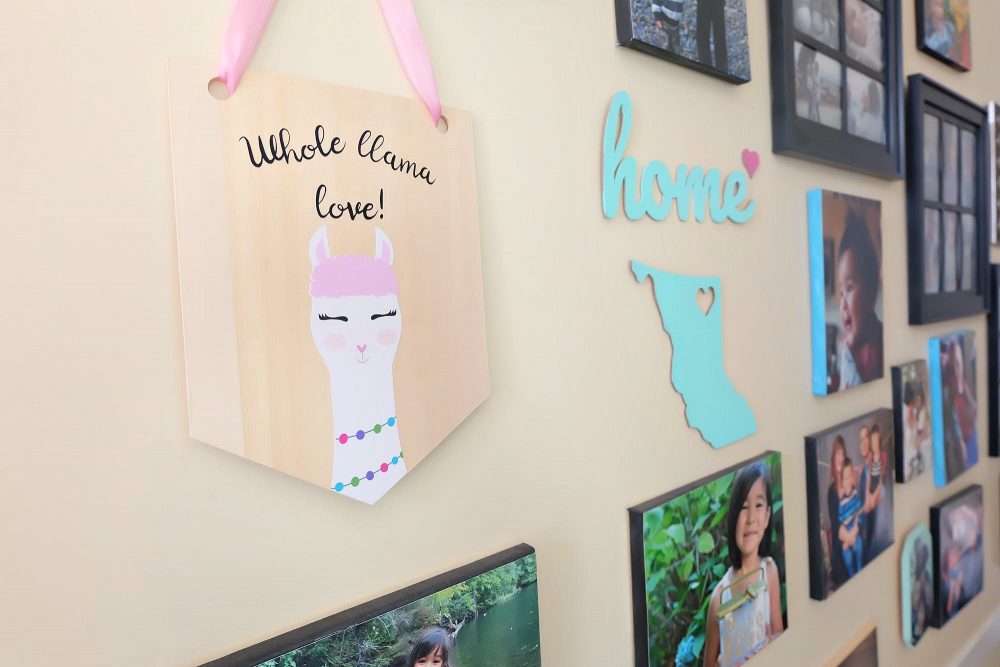 Learn how to cut basswood with your Cricut Maker and make this adorable DIY Llama Wood Wall Hanging featuring acute Print and Cut llama and the quote Whole Llama Love. This craft would make a sweet handmade gift and would be perfect for decorating a girl's bedroom or as a fun front door decoration. Another amazing Cricut Project from Hello Creative Family. #CricutProject #handmade #llama #girlsroom