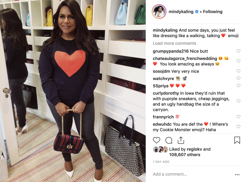 Mindy Kaling looking adorable in a black and red heart sweatshirt