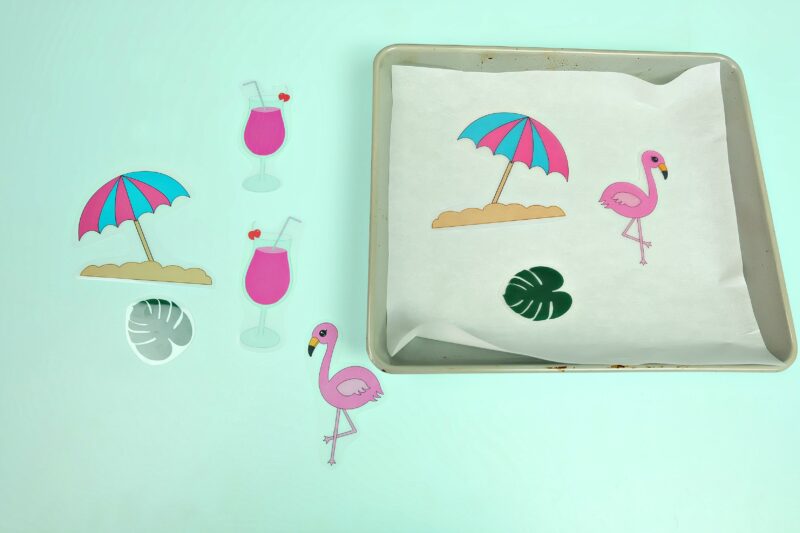 Create an adorable set of DIY Summer Flamingo Fairy Lights using shrink plastic (aka Shrinky Dinks) and our free summer flamingo printable. Perfect for summer decor or tropical themed luau birthday parties! Fun and oh so easy to make! #ShrinkyDinks #Flamingo #SummerCrafts #DIY 
