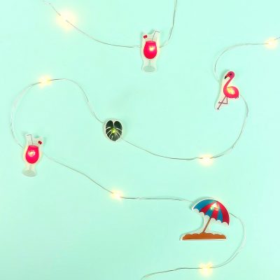 Create an adorable set of DIY Summer Flamingo Fairy Lights using shrink plastic (aka Shrinky Dinks) and our free summer flamingo printable. Perfect for summer decor or tropical themed luau birthday parties! Fun and oh so easy to make! #ShrinkyDinks #Flamingo #SummerCrafts #DIY 