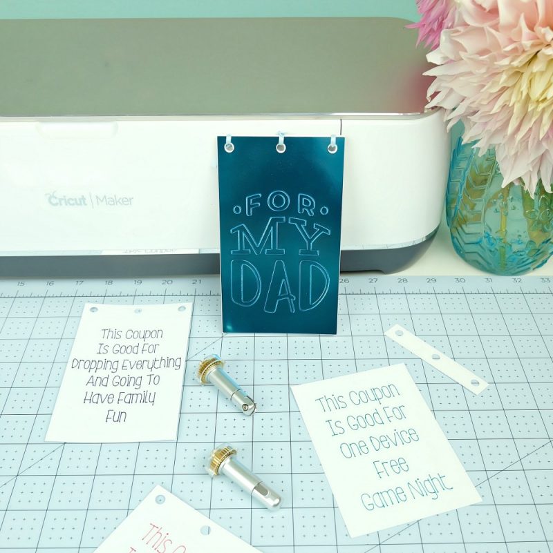Learn how to make a DIY Dad Coupon Book using your Cricut Maker Adaptive Tools! This handmade gift is the perfect gift for Dad for Father's Day, birthdays or Christmas! #CricutMaker #DadGift #handmadegift #GiftForDad #sponsored