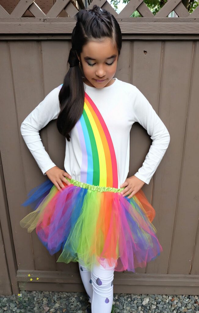 Create an Easy DIY Rainbow Halloween Costume out of leggings and a white shirt using your Cricut Maker or Cricut Explore Air 2! It's the perfect tween Halloween Costume! We're sharing step by step photos and the cut file to create this costume at home! #Cricut #HalloweenCostume #Rainbow #CricutCreated #Sponsored 