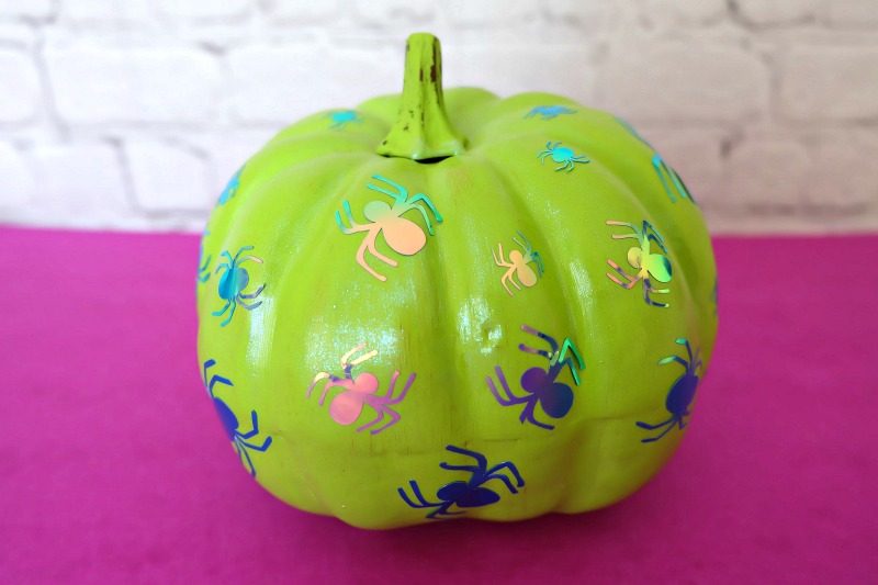 Add some flare to dollar store craft pumpkins with our easy painted pumpkins tutorial! With a bit of paint and some vinyl decals you cut with your Cricut this project makes a fun family friendly Halloween craft! #DIYHalloween #CricutCreated #Cricut #CraftPumpkins