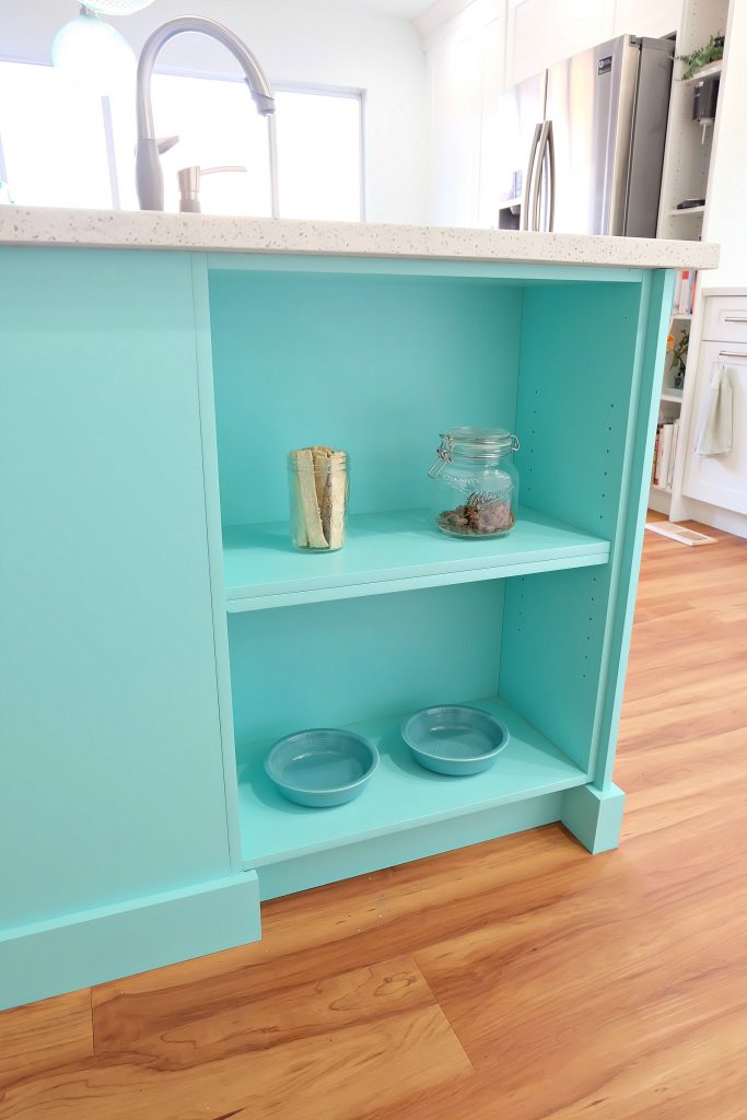 This sweet little shelf tucked into the side of a kitchen island is the perfect place to feed your pet and is a great pet friendly idea for a kitchen renovation. #Petfriendly #kitchenrenovation