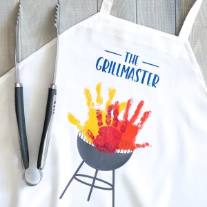 27 Cricut Gift Ideas That Take 1 Hour Or Less To Make: Handprint Grill Master Father's Day Apron from That's What Che Said
