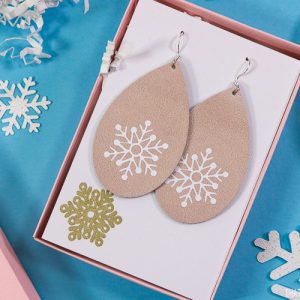 27 Cricut Gift Ideas That Take 1 Hour Or Less To Make: Leather Snowflake Earrings from That's What Che Said