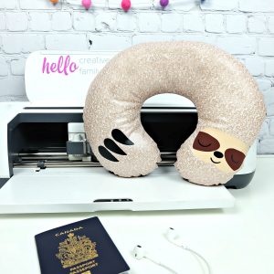Would you believe that this adorable DIY Sloth Travel Pillow takes just 20 minutes to make using your Cricut Maker? It makes the cutest quick and easy handmade gift! Whip up a batch of them for a family who loves to travel. Includes a free sloth SVG cut file and step by step Cricut sewing instructions. #Sloth #CricutMade #CricutCreated #Travel #TravelAccessories #Sewing