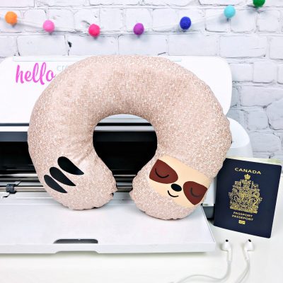 Would you believe that this adorable DIY Sloth Travel Pillow takes just 20 minutes to make using your Cricut Maker? It makes the cutest quick and easy handmade gift! Whip up a batch of them for a family who loves to travel. Includes a free sloth SVG cut file and step by step Cricut sewing instructions. #Sloth #CricutMade #CricutCreated #Travel #TravelAccessories #Sewing